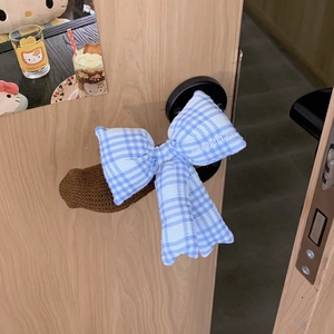 Detail of blue plaid bow door handle cover with embroidered weekend kids lettering