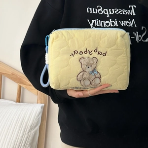 Handheld yellow quilted cosmetic bag with cute bear embroidery and light blue zipper
