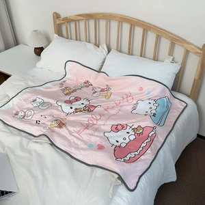 Close-up of pink coral fleece blanket with soft texture and Hello Kitty cartoon pattern