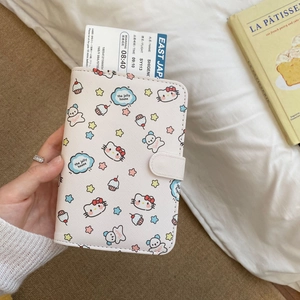 Close-up of white cartoon passport holder with star patterns and snap button closure