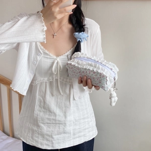Détails de dentelle et motif floral sur une trousse à crayons avec pendentif lapin