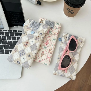 Quilted cotton sunglasses pouches with floral and bear prints featuring snap buttons