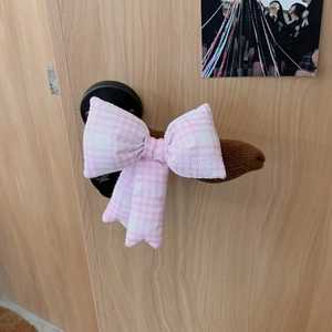 Close-up of pink checkered bow door handle cover with Weekend Hub embroidery and knit sleeve