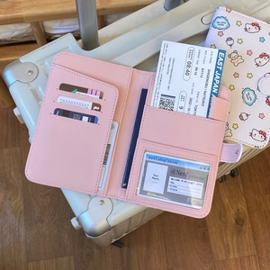 Pink passport wallet interior view on suitcase showing card slots and document holders