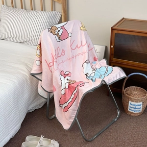 Detail of pink Hello Kitty fleece blanket with gray piping edge on a metal chair