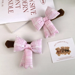 Close-up of pink checkered bow door handle covers with Weekend Club embroidery