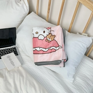 Detailed view of pink flannel blanket featuring Hello Kitty and bear cartoon patterns