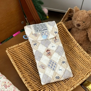 Quilted cartoon bear glasses pouch featuring a blue elastic loop and button closure