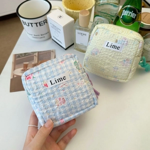 Chic quilted floral and checkered cosmetic pouch with a soft lime label for daily use