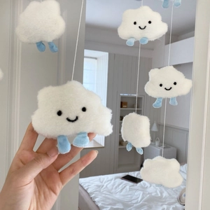 Close-up of cute plush cloud wall decor with soft texture and hanging light blue legs