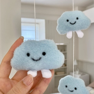Detailed view of sky blue cloud plush pendant with cute smiling face and soft texture