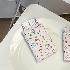 Detail of white PU leather passport holder with pink cartoon cat prints and travel card