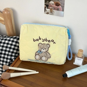 Quilted cotton makeup bag with cute plush bear embroidery and blue zipper detail