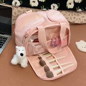 Detail view of pink travel organizer with multi-layer mesh pockets and a cute puppy charm