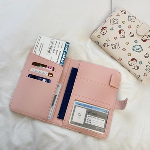 Interior layout of a pink faux leather passport holder with multiple card slots and pockets