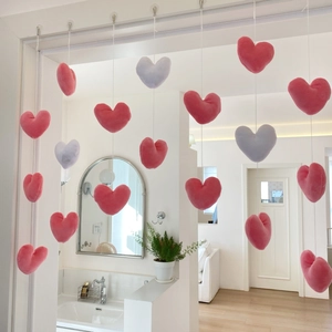 Detail of pink and purple plush heart-shaped door curtains hanging in a modern cozy room