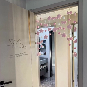 Pink plush star and bow door hanging decoration in a bedroom setting