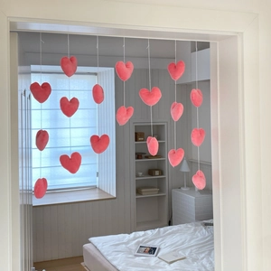 Detail of pink plush heart curtain with multi-strand design for romantic room decor
