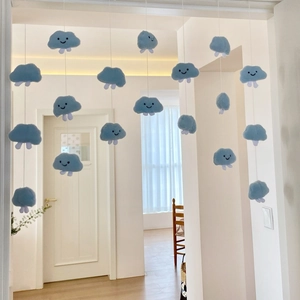 Close-up of soft blue plush cloud curtain hanging with cute embroidered smiley faces