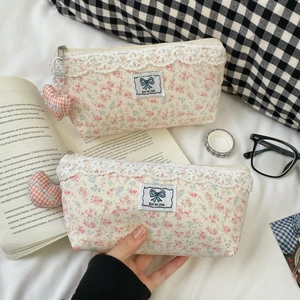 Floral lace pencil case with blue bow patch and a heart-shaped pink gingham charm