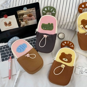 Close-up of Jolly cartoon canvas pouch handles with embroidered details and drawstring pockets