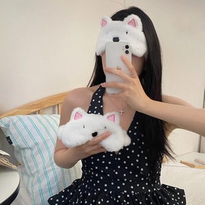 Close-up of white plush bear sleep masks with pink checkered ears and soft fur texture