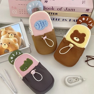 Macro shot of cartoon animal pencil cases with Jolly handles and drawstring pockets
