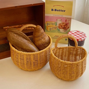Close-up of hand-woven rattan-style baskets with bread in a warm kitchen setting