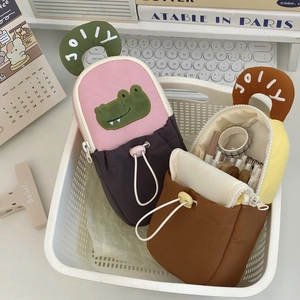 Close-up of cute cartoon stationery bags with crocodile embroidery and JOLLY handle