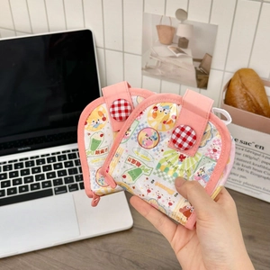 Détail des porte-monnaie roses en tissu avec boutons à carreaux rouges dans un cadre de vie