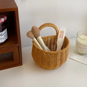 Detail of hand-woven imitation rattan storage basket with handle for organizing small items