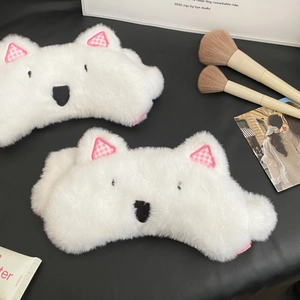 Macro detail of fluffy white plush sleep mask with cute pink plaid ears on leather