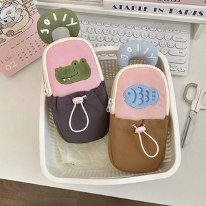 Detail of cartoon standing pencil cases with animal patches and pink drawstrings