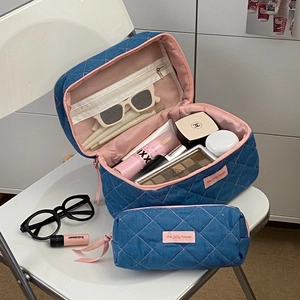 Blue quilted denim travel makeup bag set with pink zippers and spacious compartments