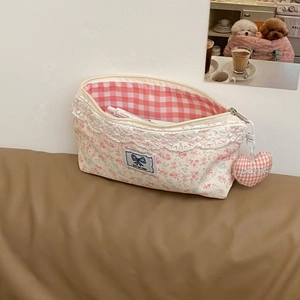 Close-up of floral lace pencil case with pink lining and Rise and shine patch detail