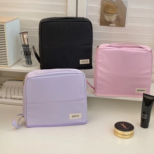 Detailed view of stackable large capacity travel toiletry bags in macaron colors
