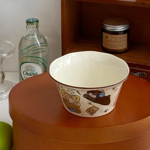 Detail of cream ceramic bowl featuring cute hand-drawn cartoon bear and star patterns