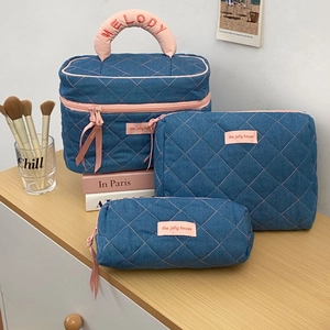 Three-piece denim quilting makeup bag set with pink stitching and Melody embroidery detail