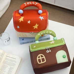 Detail of star house makeup bags with JOLLY embroidery and colorful handle beads