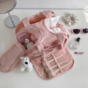 Pink multi-functional travel cosmetic bag with interior makeup brush slots and side zipper