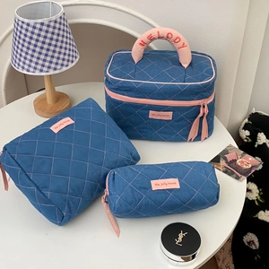 Three-piece quilted blue denim travel organizer set with pink zippers and top handle