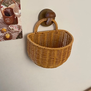 Detail of vintage faux rattan wall hanging basket with thick hand-woven texture and loop