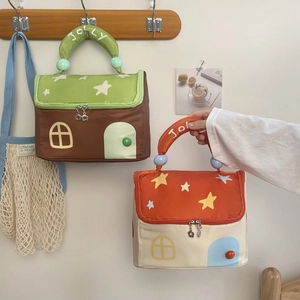 Detail of house-shaped cosmetic bag with JOLLY embroidery and star patterns