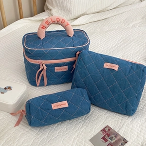 Three-piece denim toiletry bag set with pink quilting and MELODY embroidery detail