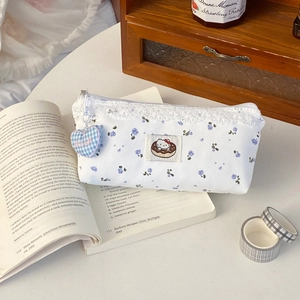 Detailed view of floral canvas pencil case with Hello Kitty patch and lace trim detail