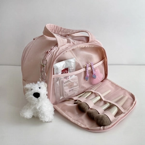 Pink multi-functional makeup bag with internal mesh pockets and a cute bear charm