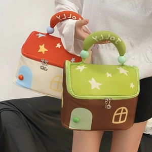 Detail of house-shaped toiletry bags with star patterns and JOLLY embroidered handles