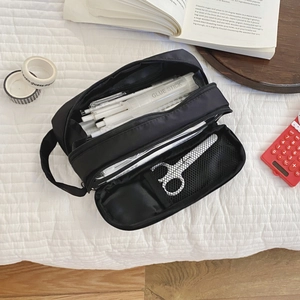 Detailed interior of the black large capacity pencil case with three-layer storage compartments