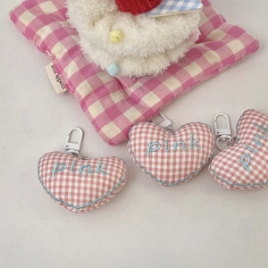 Close-up of pink checkered heart plush keychain with pink embroidery and white plastic hook