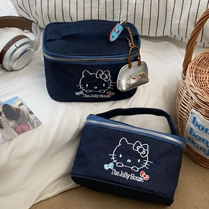 Detailed close-up of dark denim Hello Kitty cosmetic bag with embroidery and zipper